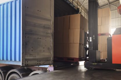 Cargo shipment loading for truck. Warehousing logistics and transportation, forklift driver loading cargo pallet into container truck .