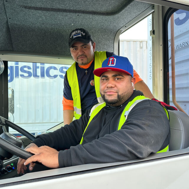 Two STG Logistics drivers.