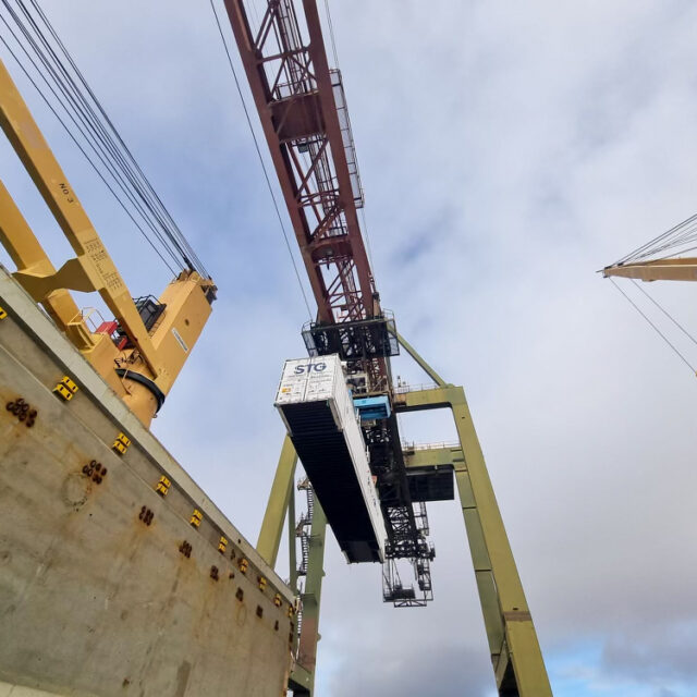 A container lifted up by a crane.