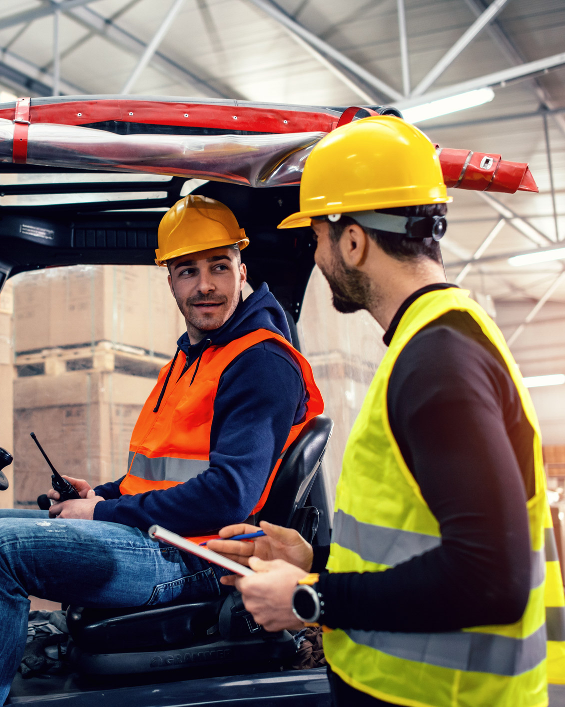 Two warehouse workers and a forklift.